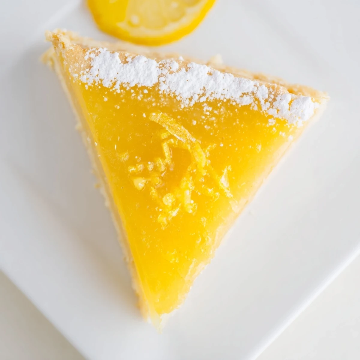 Golden, buttery shortbread crust holds a glossy, tangy lemon filling in these delicious lemon bar triangles.