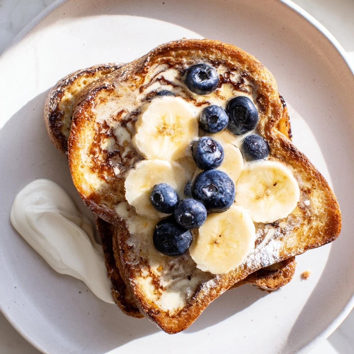 A stack of Protein French Toast, cooked to perfection, showcasing a delicious, custardy texture.