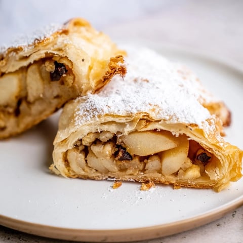 Golden, flaky apple strudel with warm cinnamon apples, perfect for dessert tonight.