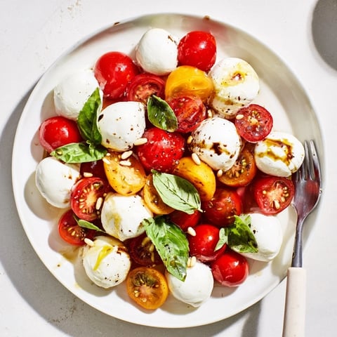 Festive Cherry Tomato and Basil Ring appetizer wreath overflowing with colorful cherry tomatoes and basil.