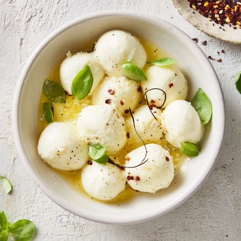 Creamy mozzarella pearls in a bowl, a simple Italian appetizer, ready to serve and enjoy.
