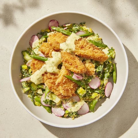 Crispy air-fried chicken nuggets atop a vibrant Green Goddess Nugget Salad, perfect for lunch.