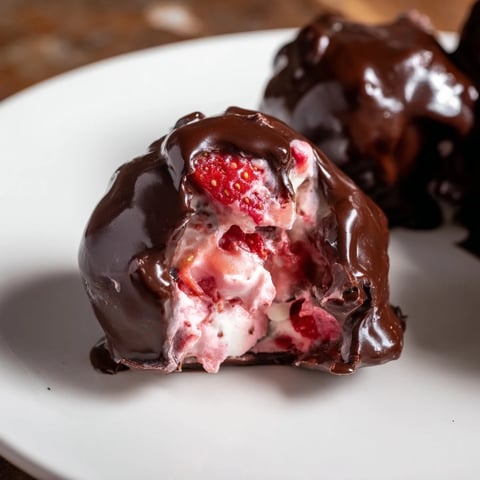 Strawberry Yogurt Clusters dipped in rich, dark chocolate, a refreshing frozen dessert treat.