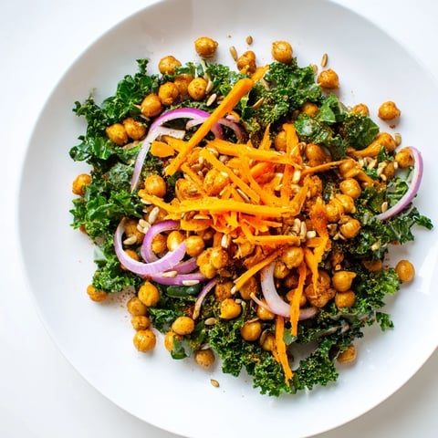 Crispy roasted chickpeas topping a fresh kale salad, a healthy and delicious meal.