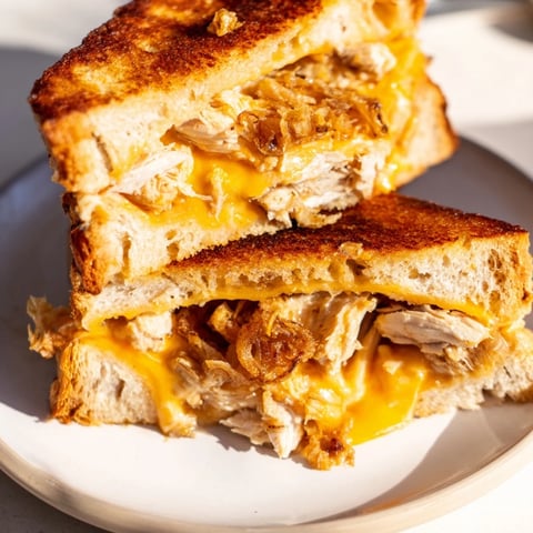 Golden, gooey Crispy Shallot Chicken Grilled Cheese, oozing melted cheddar and mozzarella, perfect for a cozy dinner.