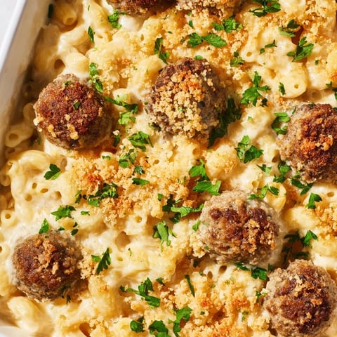 A bubbly Mac & Cheese Meatball Bake, golden topping over creamy cheese, ready to serve.