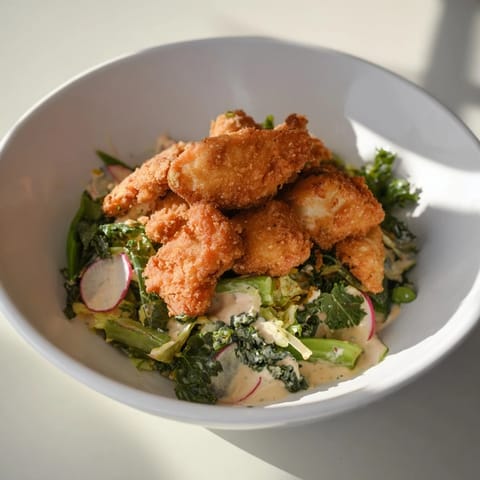 A close-up of a refreshing Green Goddess Nugget Salad, tossed in creamy dressing, ready to eat.
