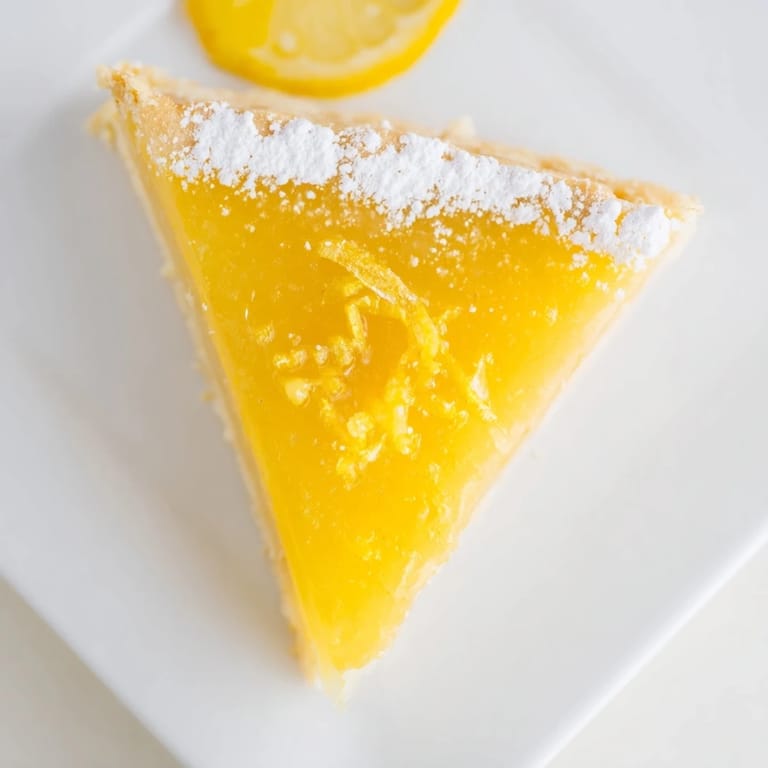Golden, buttery shortbread crust holds a glossy, tangy lemon filling in these delicious lemon bar triangles.