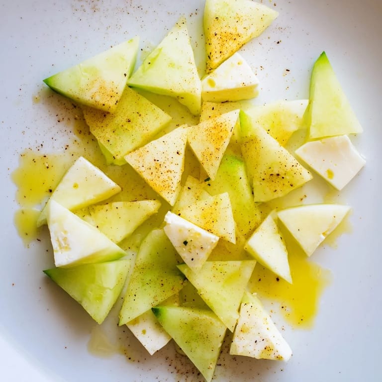 Vibrant The Cubist Deconstruction appetizer, composed of artistic vegetable shapes and feta cheese, drizzled with olive oil.