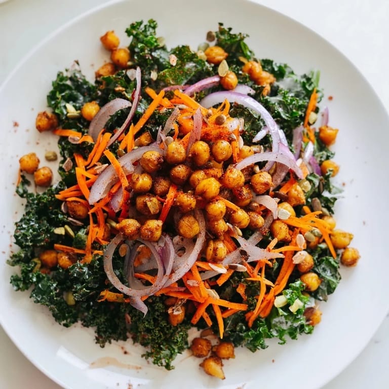 A close-up of a flavorful kale salad with spiced roasted chickpeas, full of texture.